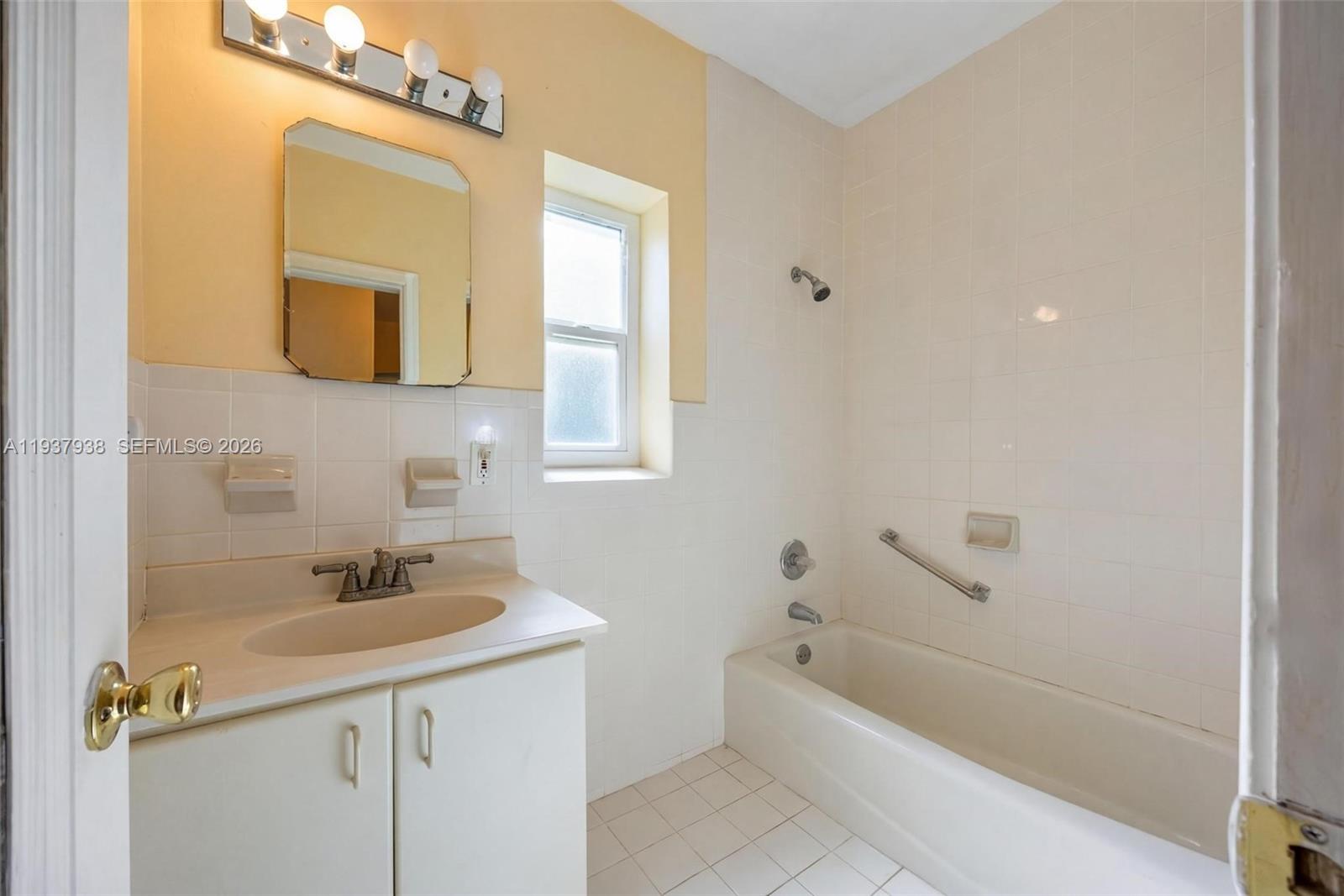 9148 Abbott Avenue Surfside, FL 33154 - Photo 25 of 37 a bathroom with a sink a toilet a mirror and shower