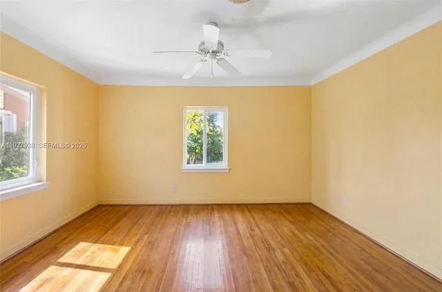 wooden floor in an empty room with a window