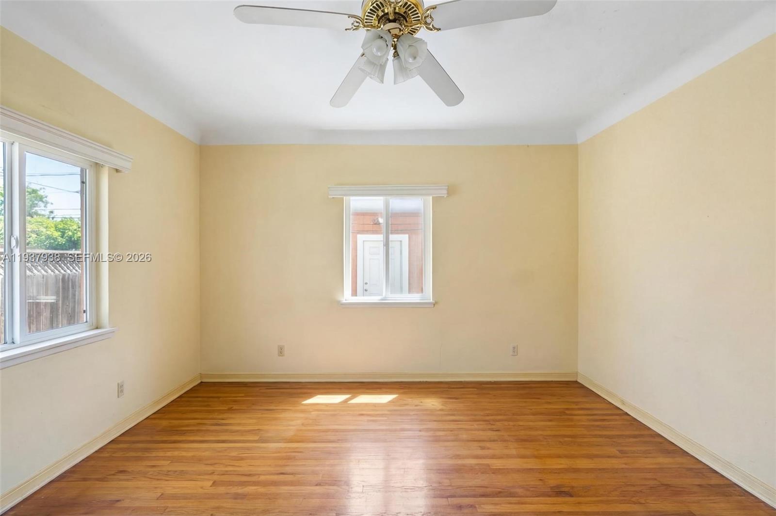9148 Abbott Avenue Surfside, FL 33154 - Photo 27 of 37 a view of an empty room with wooden floor and a window