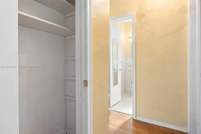 a view of a hallway with wooden floor