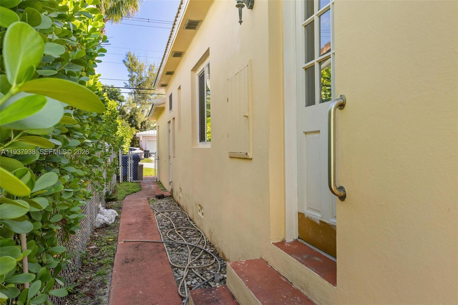 9148 Abbott Avenue Surfside, FL 33154 - Photo 30 of 37 a view of a pathway of a house with potted plants