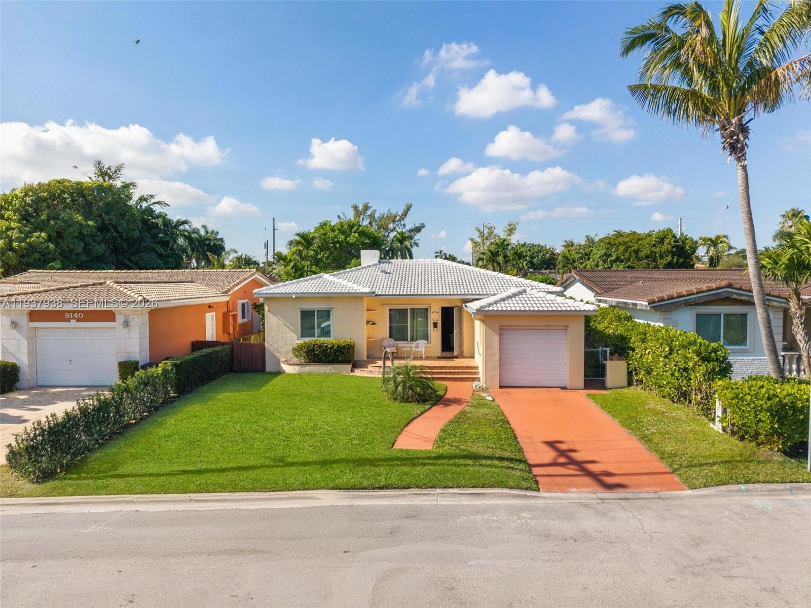 9148 Abbott Avenue Surfside, FL 33154 - Photo 33 of 37 a front view of a house with garden