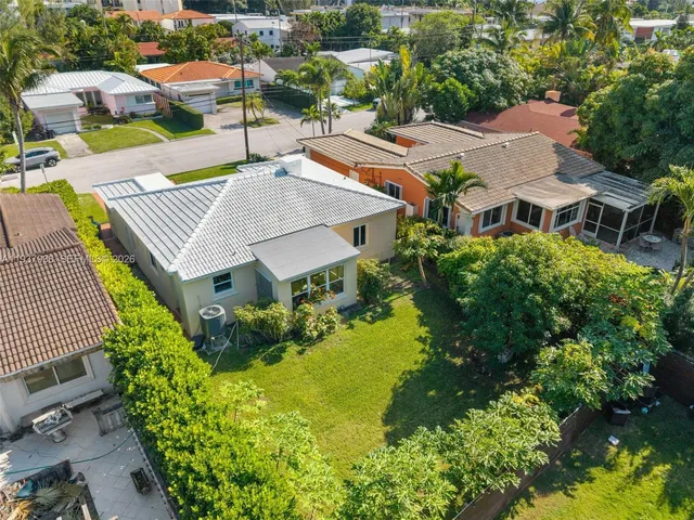 an aerial view of a house with garden space and street view
