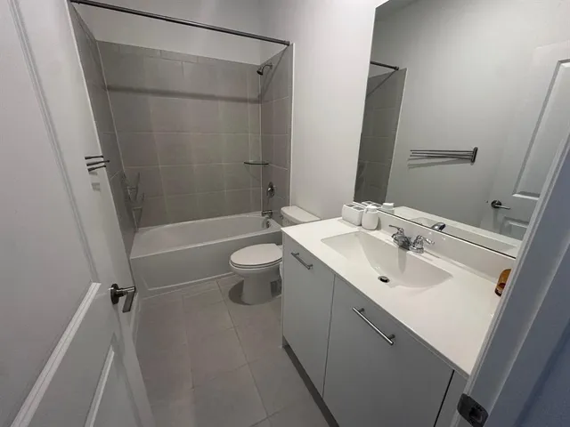 a bathroom with a sink mirror toilet and bathtub