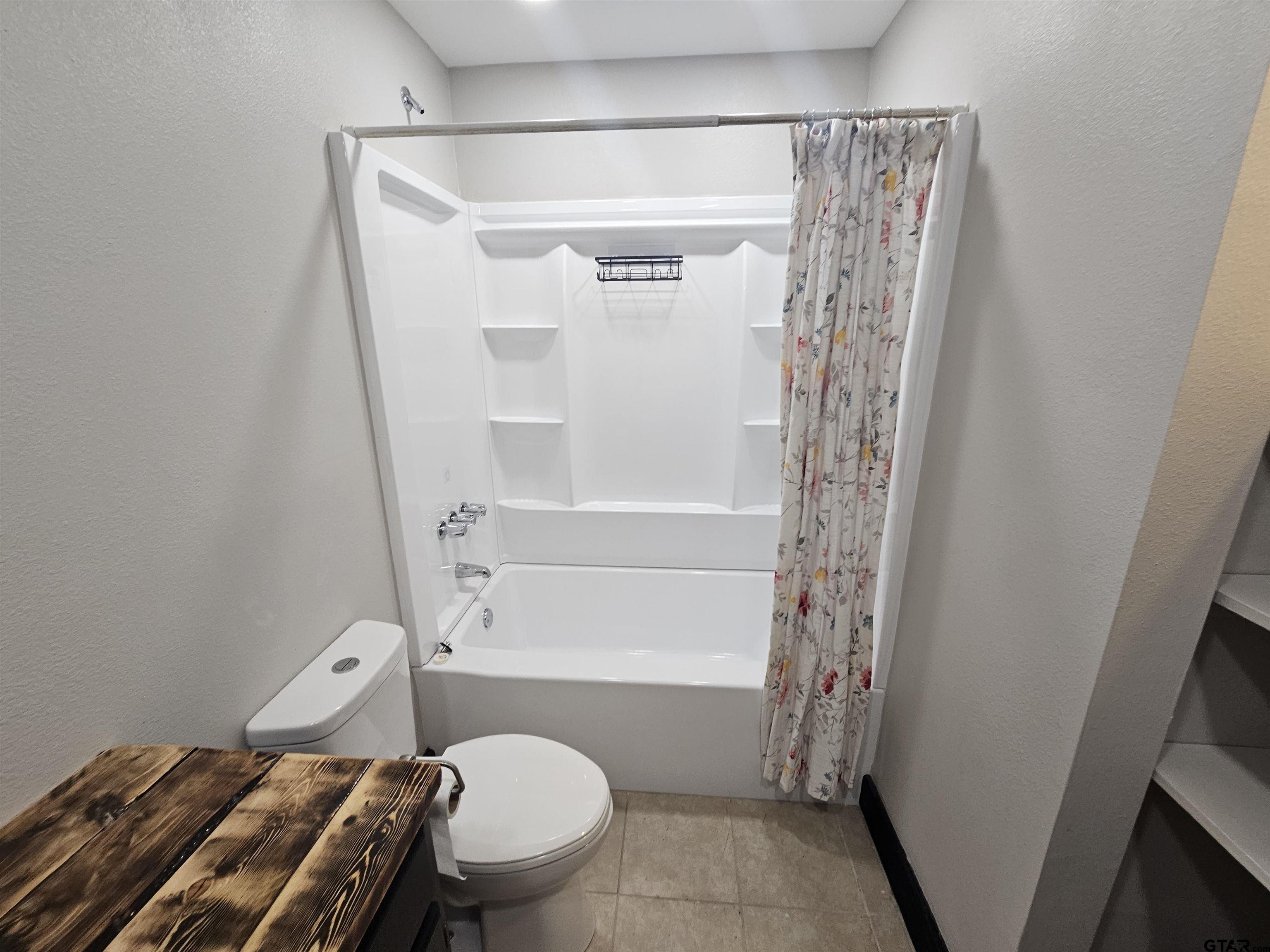 109 Tomie Street Quitman, TX 75783 - Photo 20 of 32 a bathroom with a toilet and a shower