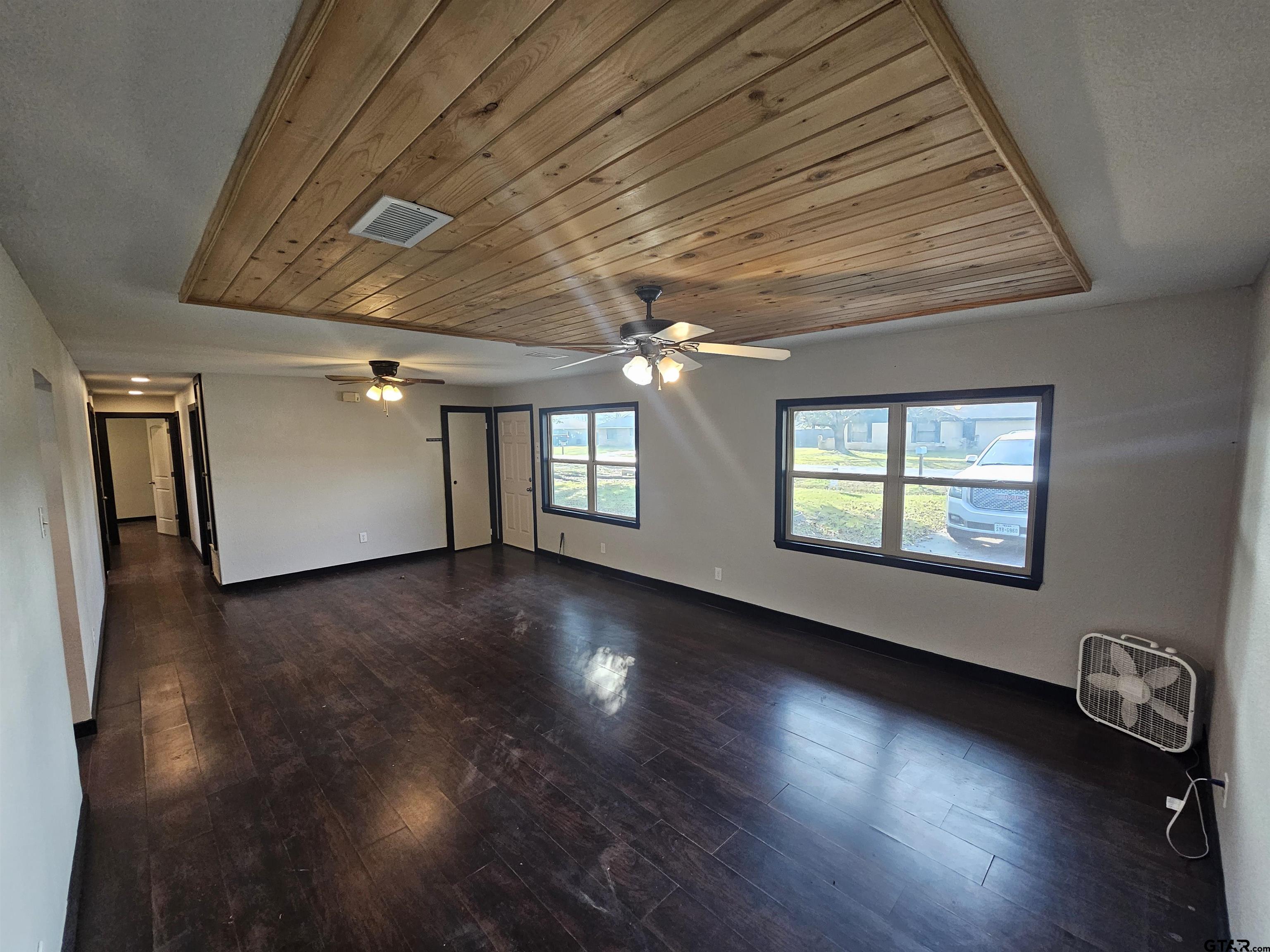 109 Tomie Street Quitman, TX 75783 - Photo 6 of 32 a view of empty room with wooden floor