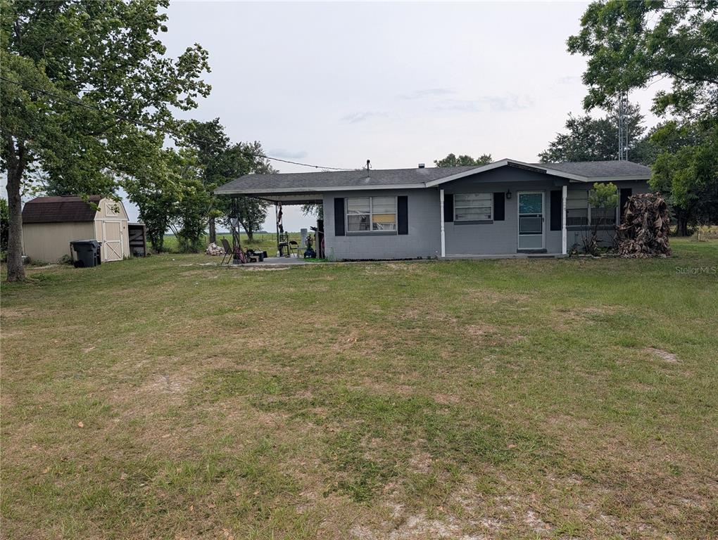 4190 80 Foot Road Bartow, FL 33830 - Photo 1 of 1 a front view of a house with a garden