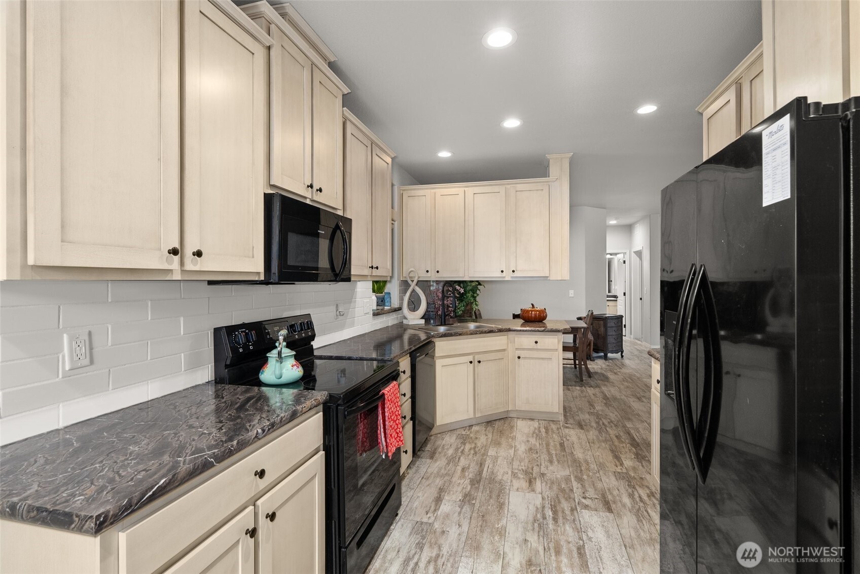 4 Lakeview Lane South Bend, WA 98586 - Photo 21 of 40 a kitchen with a sink a refrigerator and cabinets