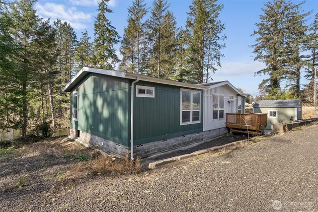 a view of a backyard with plants and a lake view