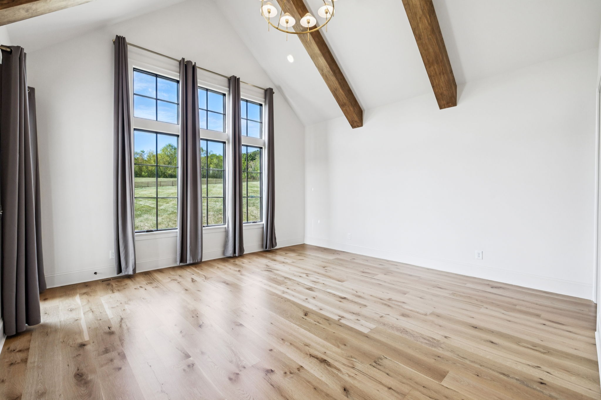 2245 Skinner Road Arrington, TN 37014 - Photo 48 of 98 a view of an empty room with wooden floor and windows