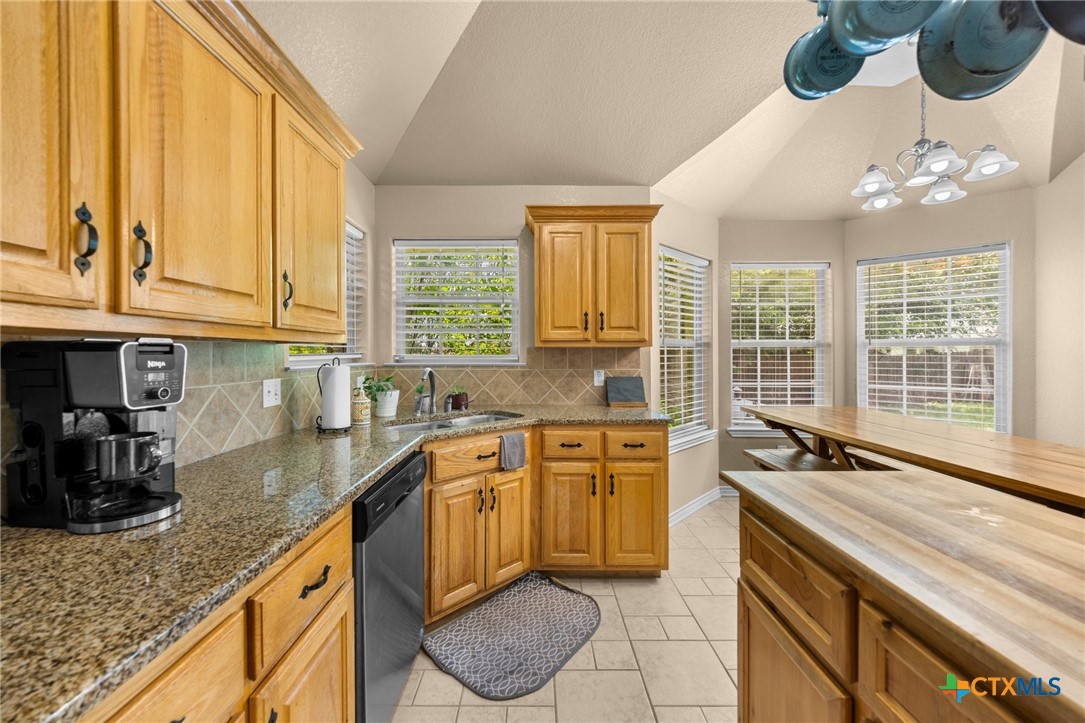 108 Gehler Circle Nolanville, TX 76559 - Photo 13 of 27 a kitchen with granite countertop a sink window and cabinets