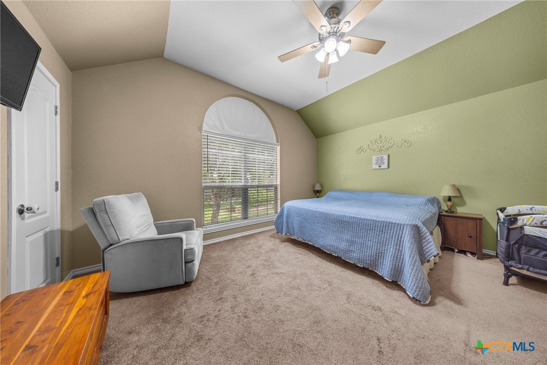 108 Gehler Circle Nolanville, TX 76559 - Photo 16 of 27 a bedroom with a bed and a chandelier