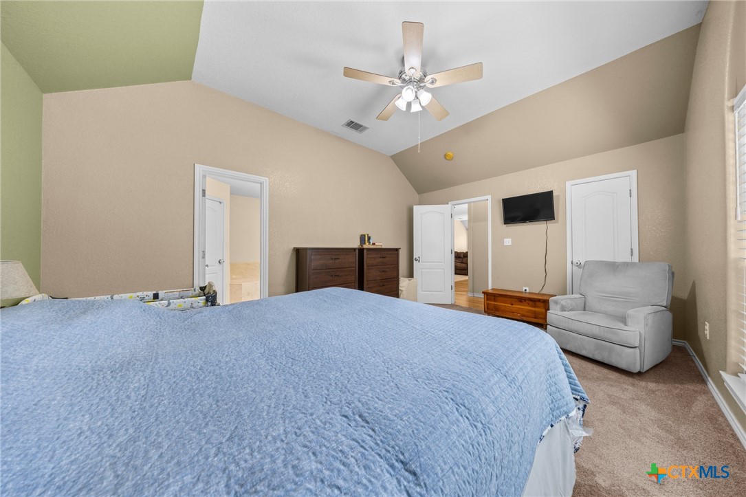 108 Gehler Circle Nolanville, TX 76559 - Photo 17 of 27 a spacious bedroom with a large bed and chandelier