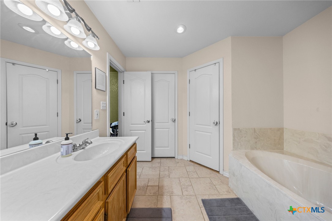 108 Gehler Circle Nolanville, TX 76559 - Photo 20 of 27 a bathroom with a tub a sink and a large mirror