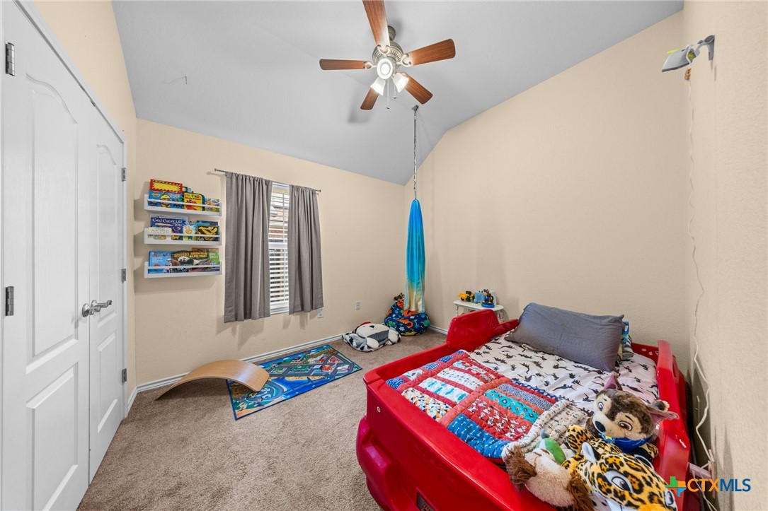 108 Gehler Circle Nolanville, TX 76559 - Photo 23 of 27 a bedroom with bed and a chandelier