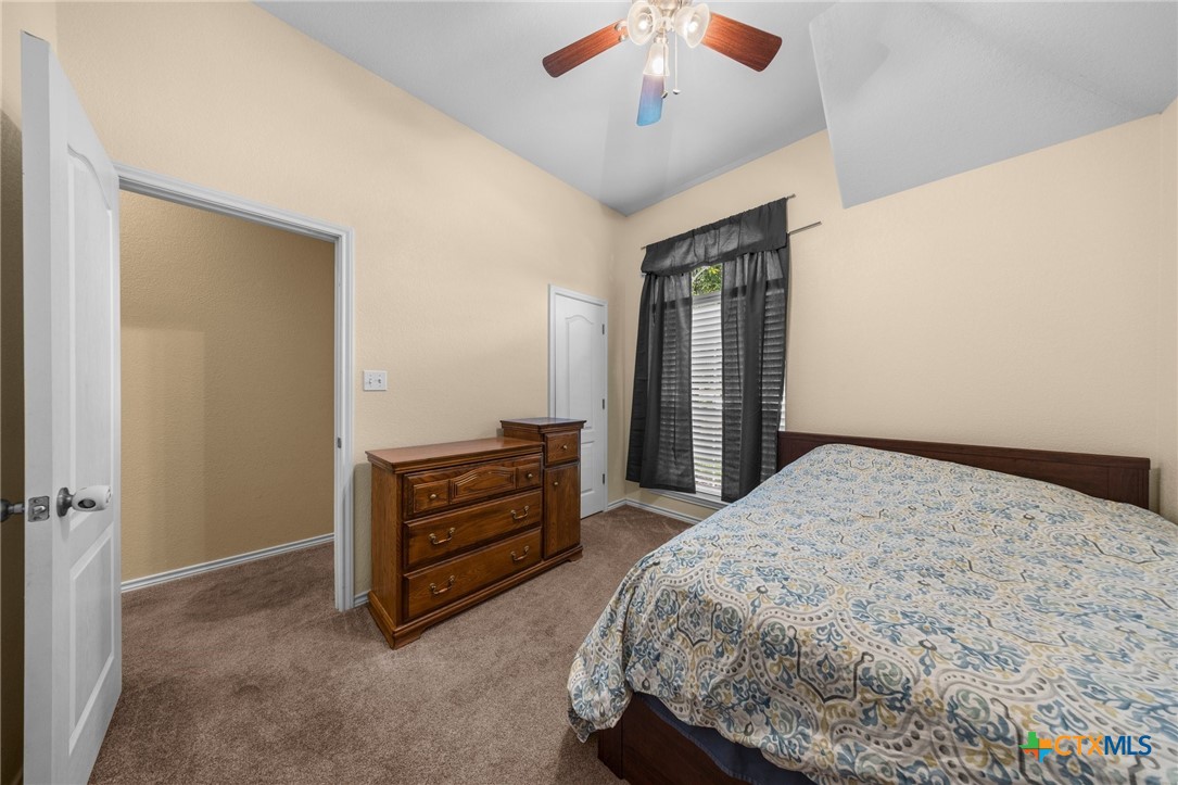108 Gehler Circle Nolanville, TX 76559 - Photo 24 of 27 a bedroom with a bed and a chandelier