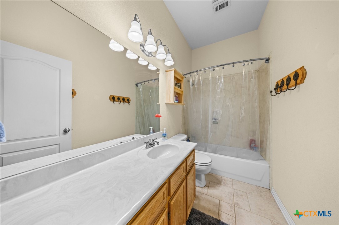 108 Gehler Circle Nolanville, TX 76559 - Photo 25 of 27 a bathroom with a granite countertop sink a toilet and shower