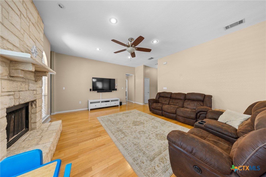 108 Gehler Circle Nolanville, TX 76559 - Photo 6 of 27 a living room with furniture ceiling fan and a fireplace