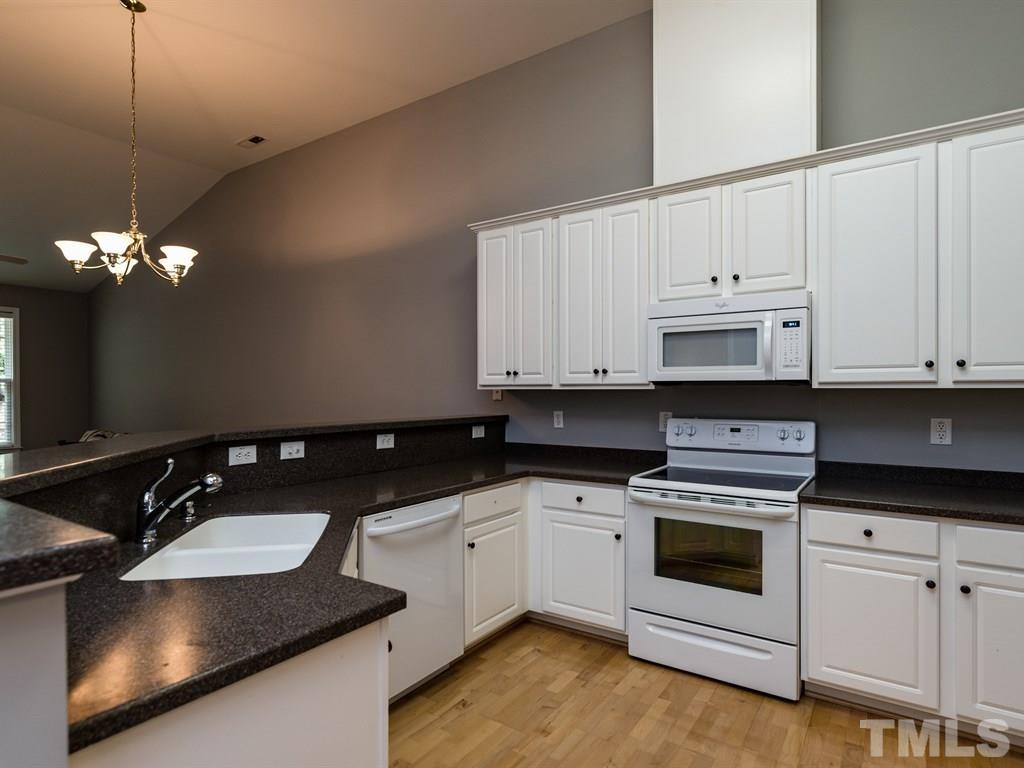 10483 Dapping Drive Raleigh, NC 27614 - Photo 2 of 21 a kitchen that has a sink and a stove