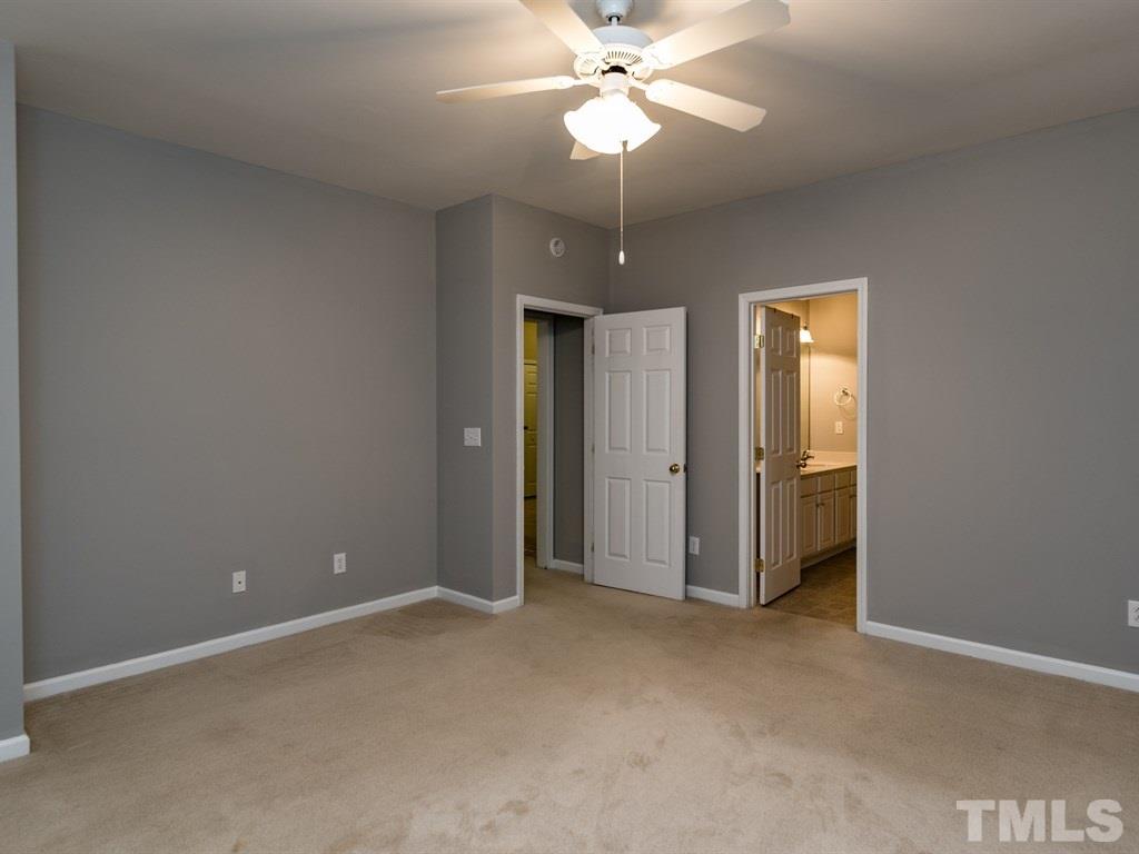 10483 Dapping Drive Raleigh, NC 27614 - Photo 10 of 21 an empty room with closet and a chandelier fan