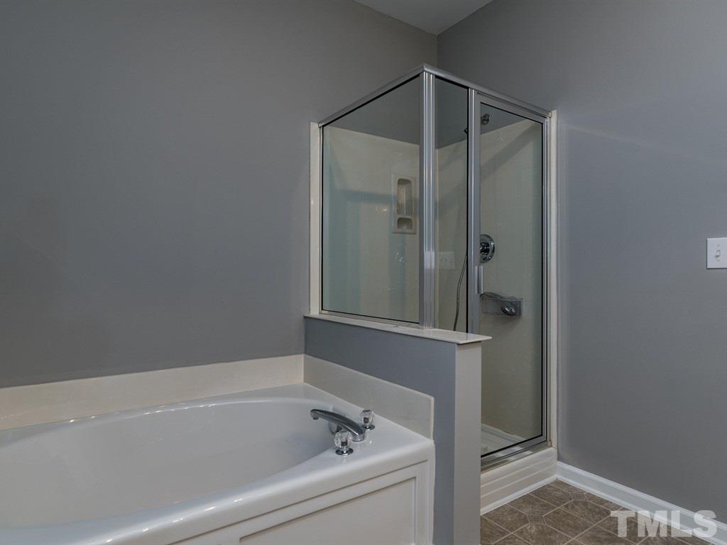 10483 Dapping Drive Raleigh, NC 27614 - Photo 13 of 21 a bathroom with a bathtub and a shower
