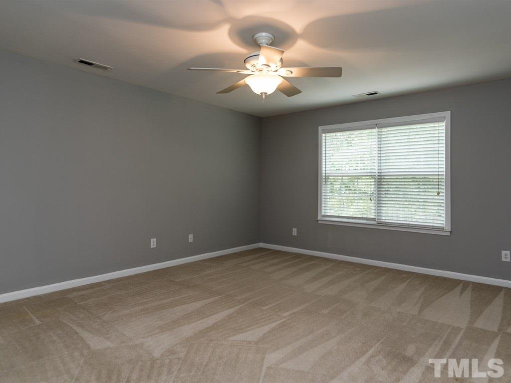 10483 Dapping Drive Raleigh, NC 27614 - Photo 17 of 21 an empty room with windows and chandelier fan