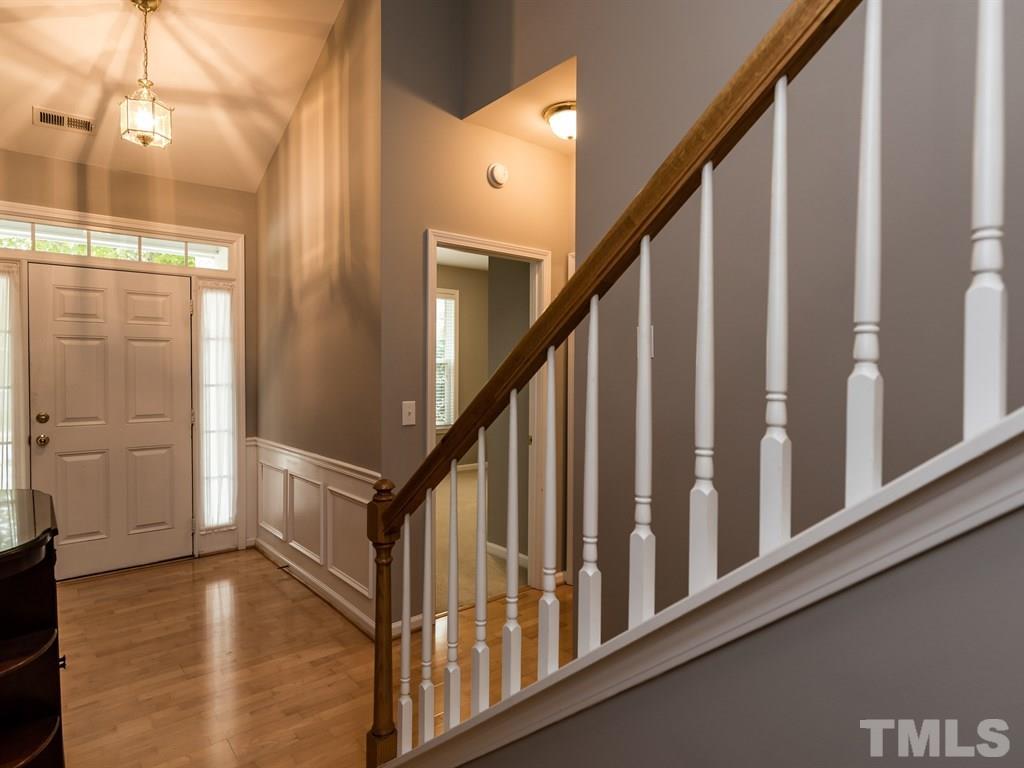 10483 Dapping Drive Raleigh, NC 27614 - Photo 5 of 21 a view of staircase with railing and a chandelier