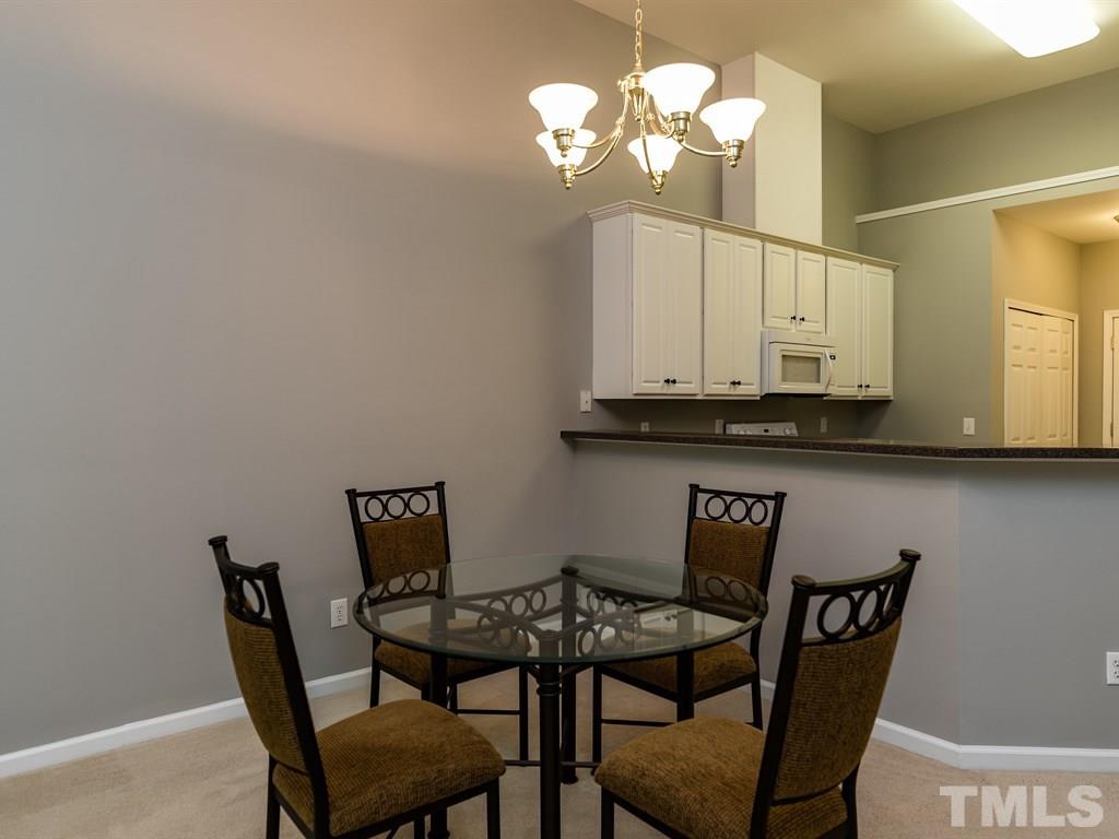 10483 Dapping Drive Raleigh, NC 27614 - Photo 6 of 21 a view of a dining room with furniture and chandelier