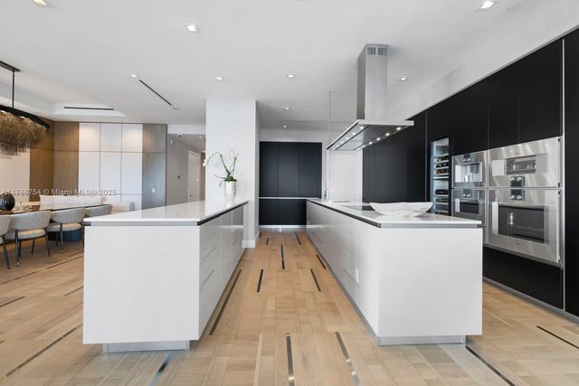 a view of living room kitchen and entryway