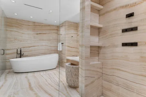 a bathroom with a granite countertop toilet a sink and a mirror