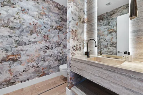 a large bed sitting in a bedroom next to a window