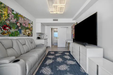 a room with lots of furniture and wooden floor