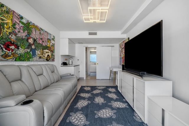 a room with lots of furniture and wooden floor