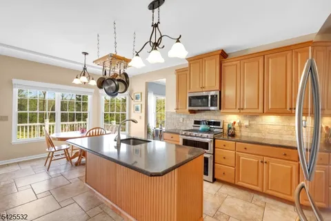 a kitchen with a large window and cabinets