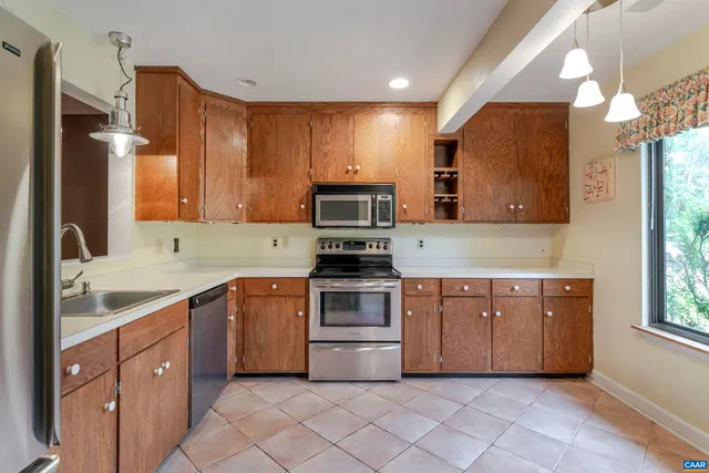 a kitchen with stainless steel appliances a stove sink and cabinets