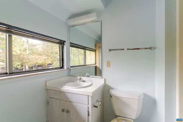 a bathroom with a sink toilet and a mirror