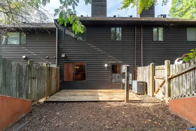 a view of a house with a window and wooden fence