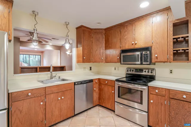 a kitchen with a sink stove and microwave