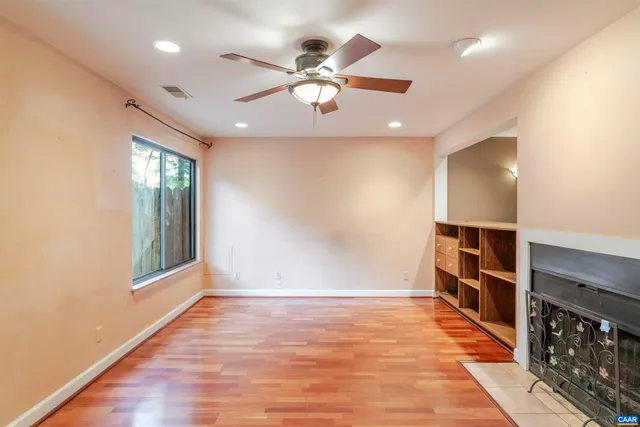 an empty room with windows and closet