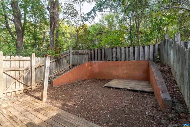a view of a backyard with wooden fence