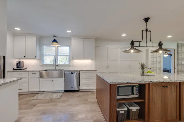 a kitchen with a stove a sink and a refrigerator