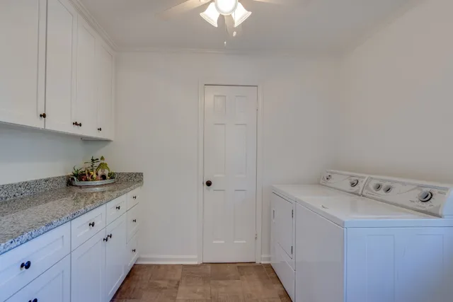 a room with cabinets and washer dryer