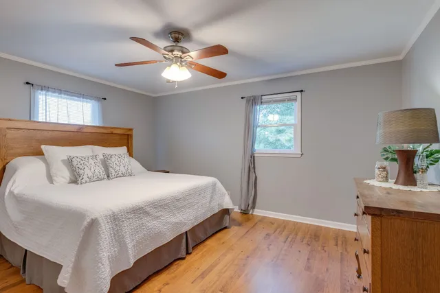 a bedroom with a bed and a chandelier