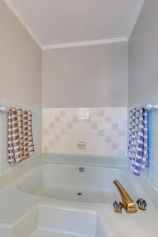 a bedroom with a bed a chair and a large window