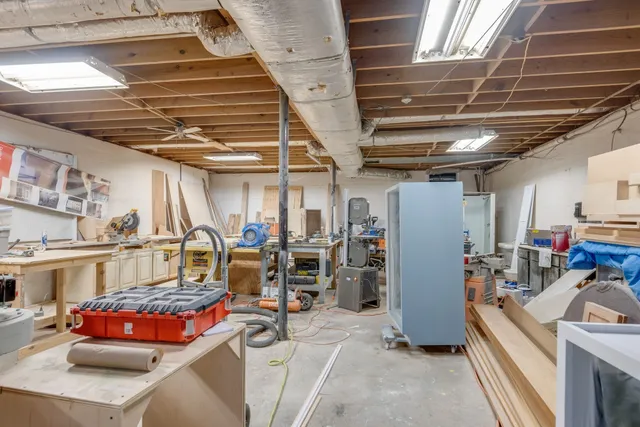 a view of a patio with table and chairs and potted plants with wooden floor and fence