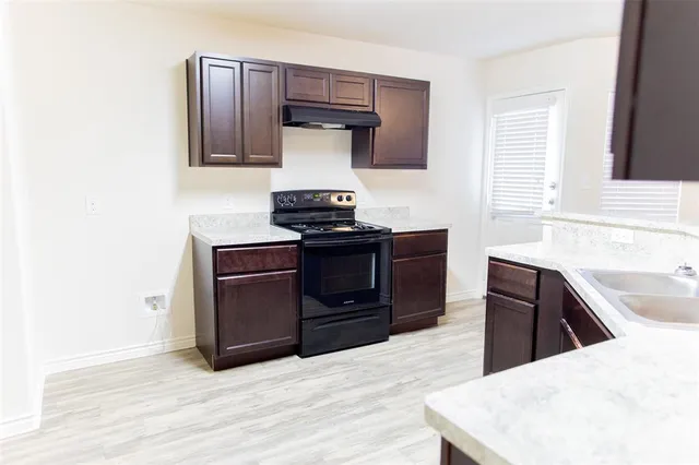 a kitchen with a stove and a refrigerator