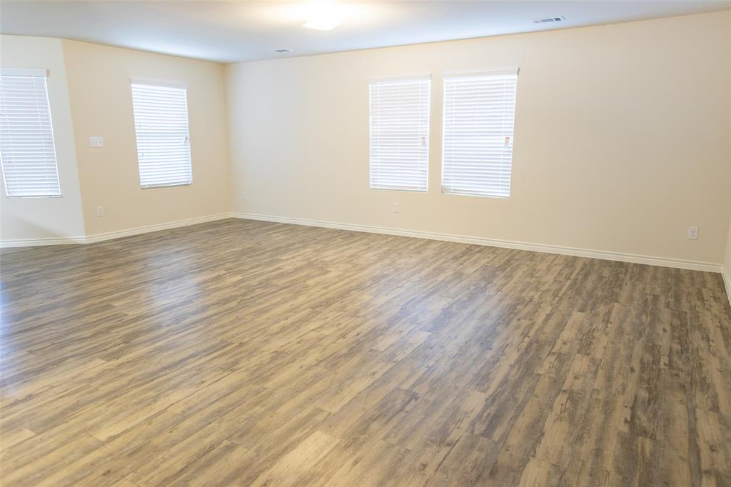 3526 Apple Valley Way Dallas, TX 75227 - Photo 4 of 13 an empty room with wooden floor and windows
