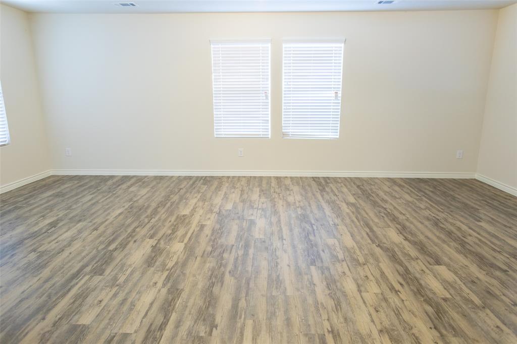 3526 Apple Valley Way Dallas, TX 75227 - Photo 5 of 13 an empty room with wooden floor and windows