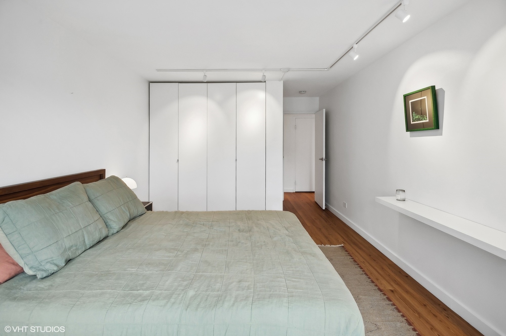 3100 North Lake Shore Drive, Unit 1404 Chicago, IL 60657 - Photo 11 of 15 a spacious bedroom with a bed and painting on the wall