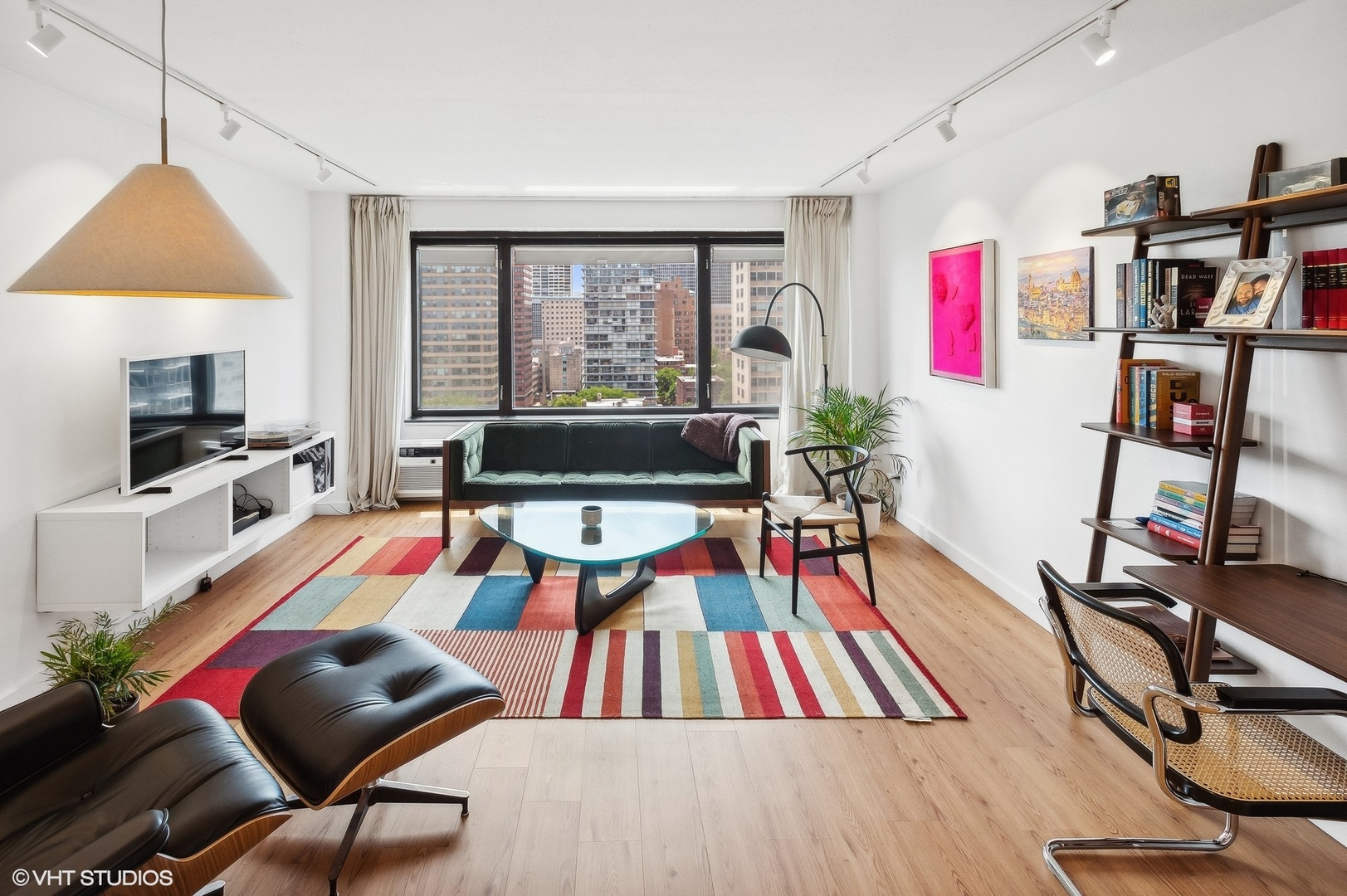 3100 North Lake Shore Drive, Unit 1404 Chicago, IL 60657 - Photo 2 of 15 a living room with furniture a rug and a flat screen tv